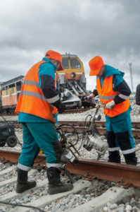 Railway workers repairing rail